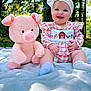 baby, child, smiling, outdoor, plush_toy, stuffed_animal, blanket, headband, bow, trees, grass, sunlight, happy, cute, infant, nature, sitting, clothing, portrait, playful