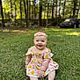 baby, child, grass, outdoor, smiling, flower_headband, dress, greenery, nature, sunlight, trees, parked_car, cute, happy, sitting, portrait, infant, summer, playful, young