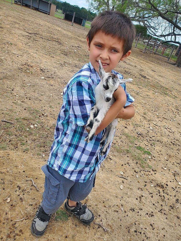Aden is registered to the contest to win money with this photo: electric_blue, grass, hair, happy, joy, landscape, leg, pattern, people_in_nature, person, plaid, plant, recreation, shoe, sky, sleeve, smile, sneakers, soil, street_fashion