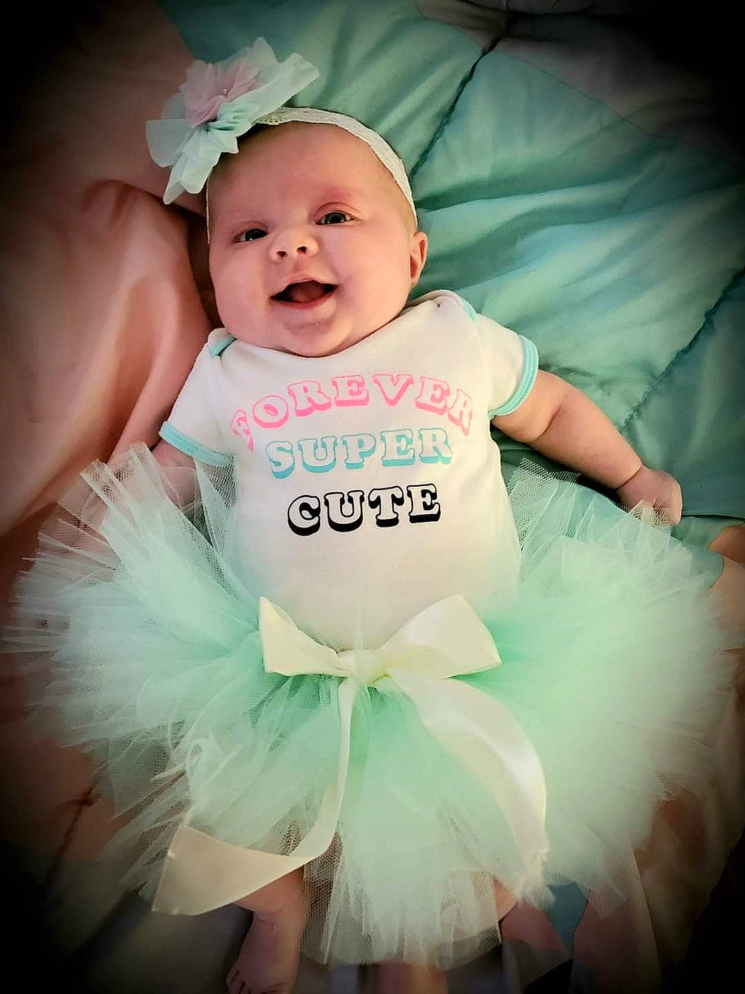 Lorraina is registered to the contest to win money with this photo: aqua, azure, baby, baby_toddler_clothing, ballet_tutu, child, dress, event, flash_photography, happy, headgear, headpiece, light, magenta, person, pink, skin, smile, textile, toddler