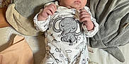 Kenzo participe au concours pour gagner de l'argent avec cette photo : baby, infant, elephant, plush_pillow, bed, blanket, hat, onesie, gray_socks, cute, soft_toys, sleepwear, newborn, lying_down, indoors, child, adorable, cozy, fabric, resting