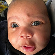 Timothy joined the competition — help win amazing prizes! baby, close_up, face, blue_eyes, curly_hair, expression, infant, skin, blanket, cozy, mouth, nose, eyelashes, portrait, child, cute, young, indoor, person, newborn