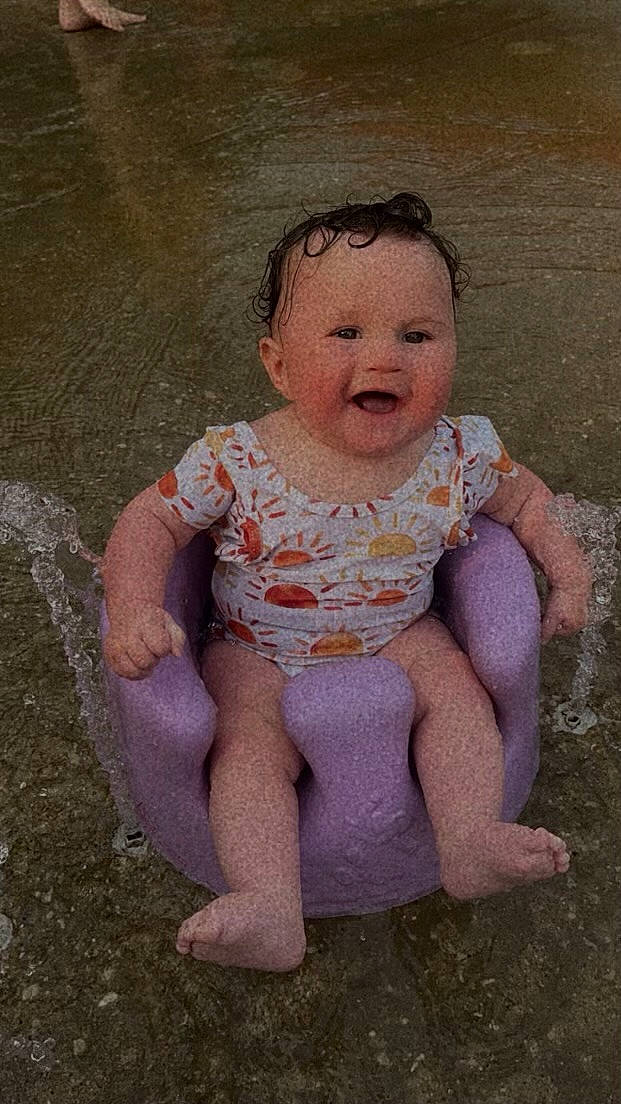 Lyanna is registered to the contest to win money with this photo: art, baby, baby_toddler_clothing, cheek, child, chin, eye, finger, foot, fun, grass, happy, head, joy, leg, person, pink, sitting, skin, sleeve