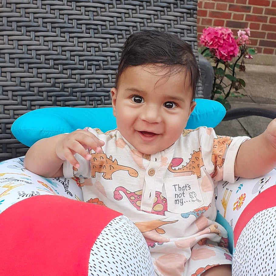 Viyaan is registered to the contest to win money with this photo: baby, brick, clothing, cushion, face, flower, furniture, head, homedecor, jar, person, photography, plant, planter, portrait, pottedplant, pottery, shorts, summer, vase