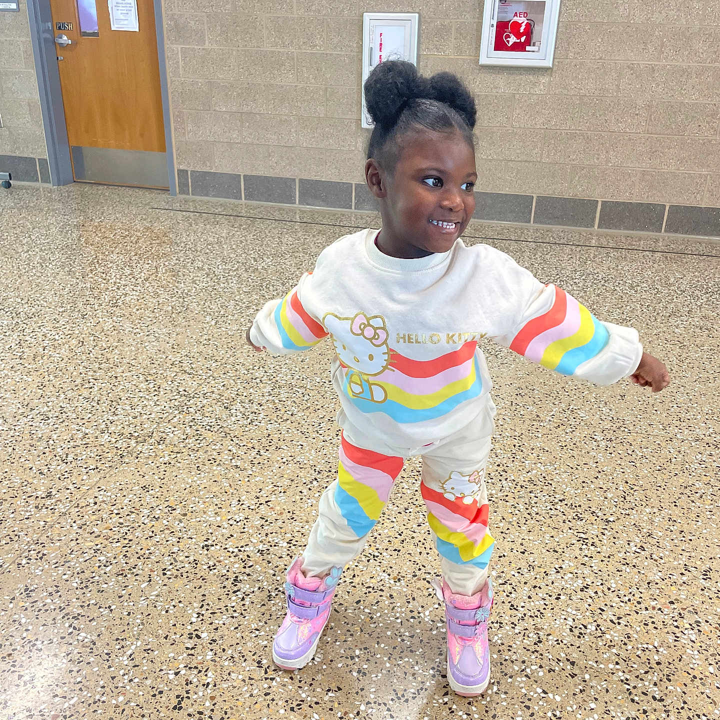 Baila is registered to the contest to win money with this photo: boots, casual, child, colorful_clothing, cute, door, fashion, floor, girl, hair, hallway, happy, health_office, hello_kitty, indoor, person, playful, pose, smiling, young