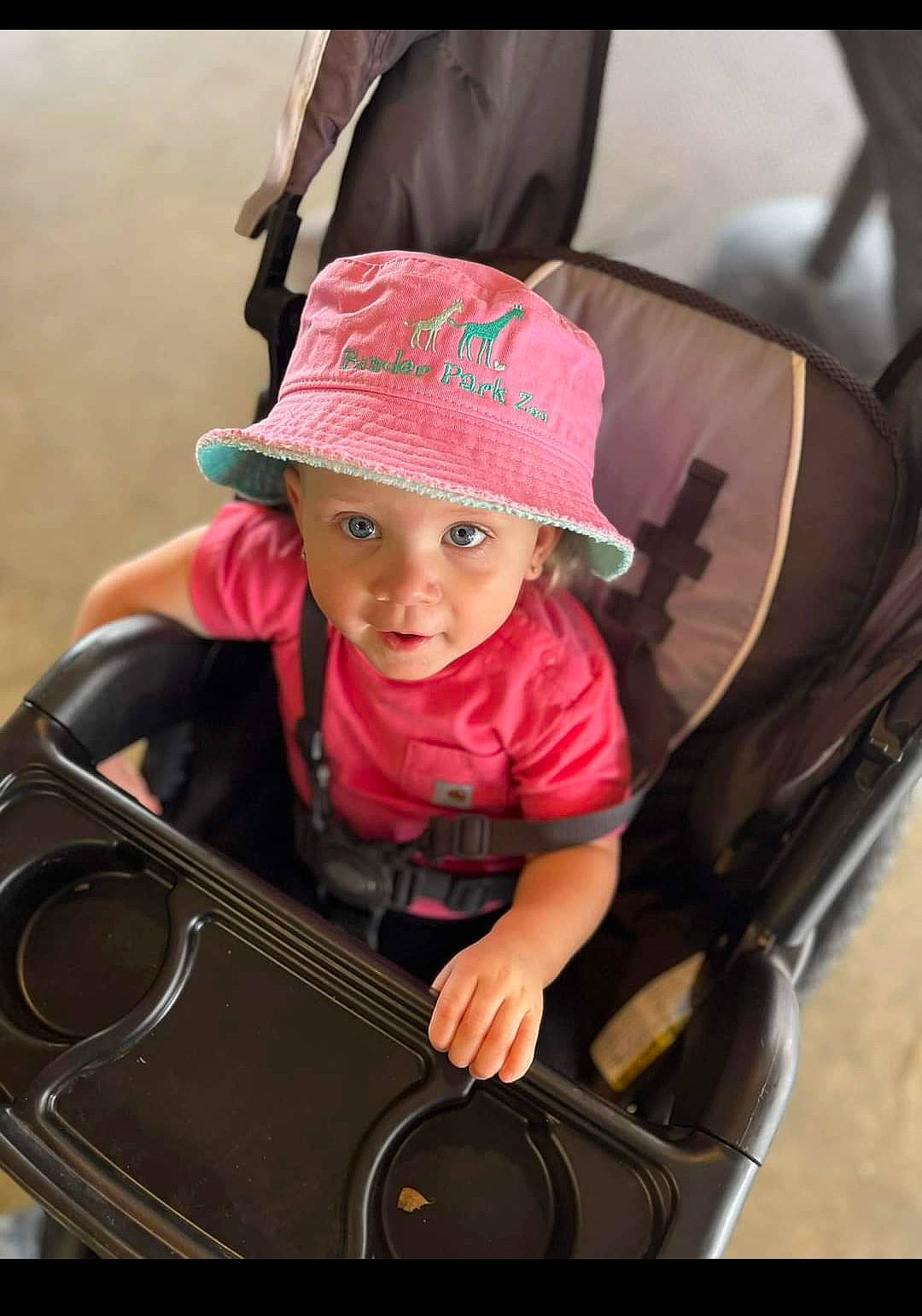 Brylie is registered to the contest to win money with this photo: auto_part, baby, baby_carriage, baby_products, bag, cap, child, fashion_accessory, fun, happy, hat, headwear, luggage_and_bags, magenta, motor_vehicle, person, personal_protective_equipment, recreation, sitting, sun_hat