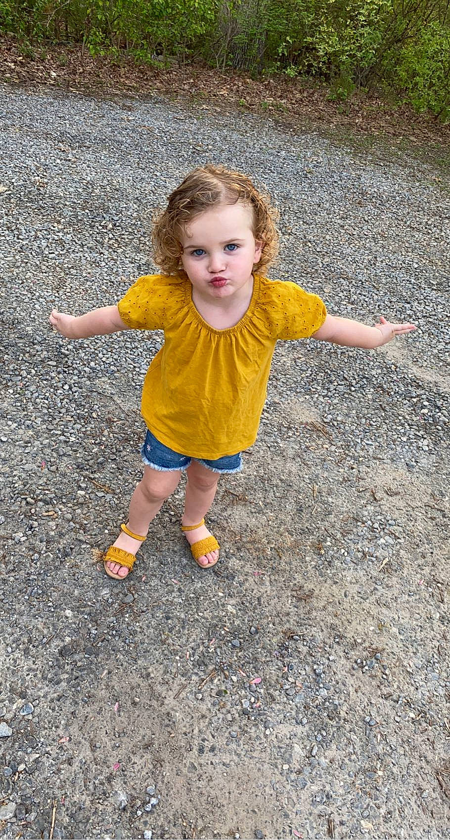 Lauren joined the competition — help win amazing prizes! asphalt, face, facial_expression, footwear, fun, gesture, grass, hair, happy, head, leisure, people_in_nature, person, plant, recreation, road, road_surface, sidewalk, standing, toddler