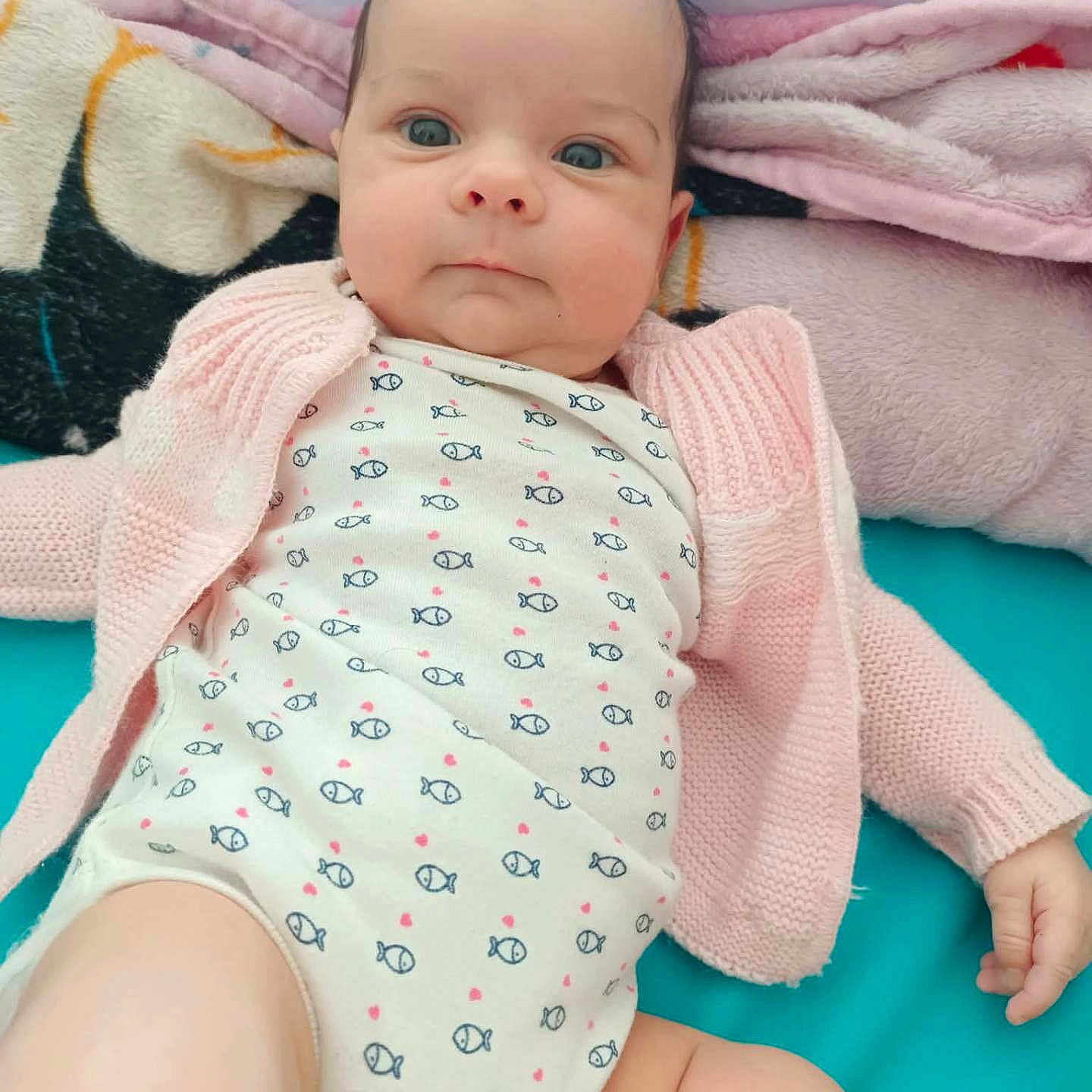 Elmeralda a rejoint le concours — aidez-le/la à gagner de superbes lots ! baby, blanket, blue_eyes, cardigan, child, clothing, cute, expression, fabric, face, hand, indoors, infant, leg, lying_down, onesie, pacifier, portrait, skin, soft_toy