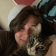 Maple joined the competition — help win amazing prizes! person, cat, tabby_cat, face, smile, hair, whiskers, closeup, indoor, couch, blanket, cozy, pet, companion, relaxing, portrait, feline, snuggling, happy, casual