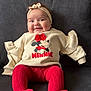 baby, infant, child, smiling, headband, minnie_mouse, red_tights, sweater, couch, sofa, sitting, portrait, indoor, cute, chubby_cheeks, long_sleeves, knit_tights, bow, face, cozy