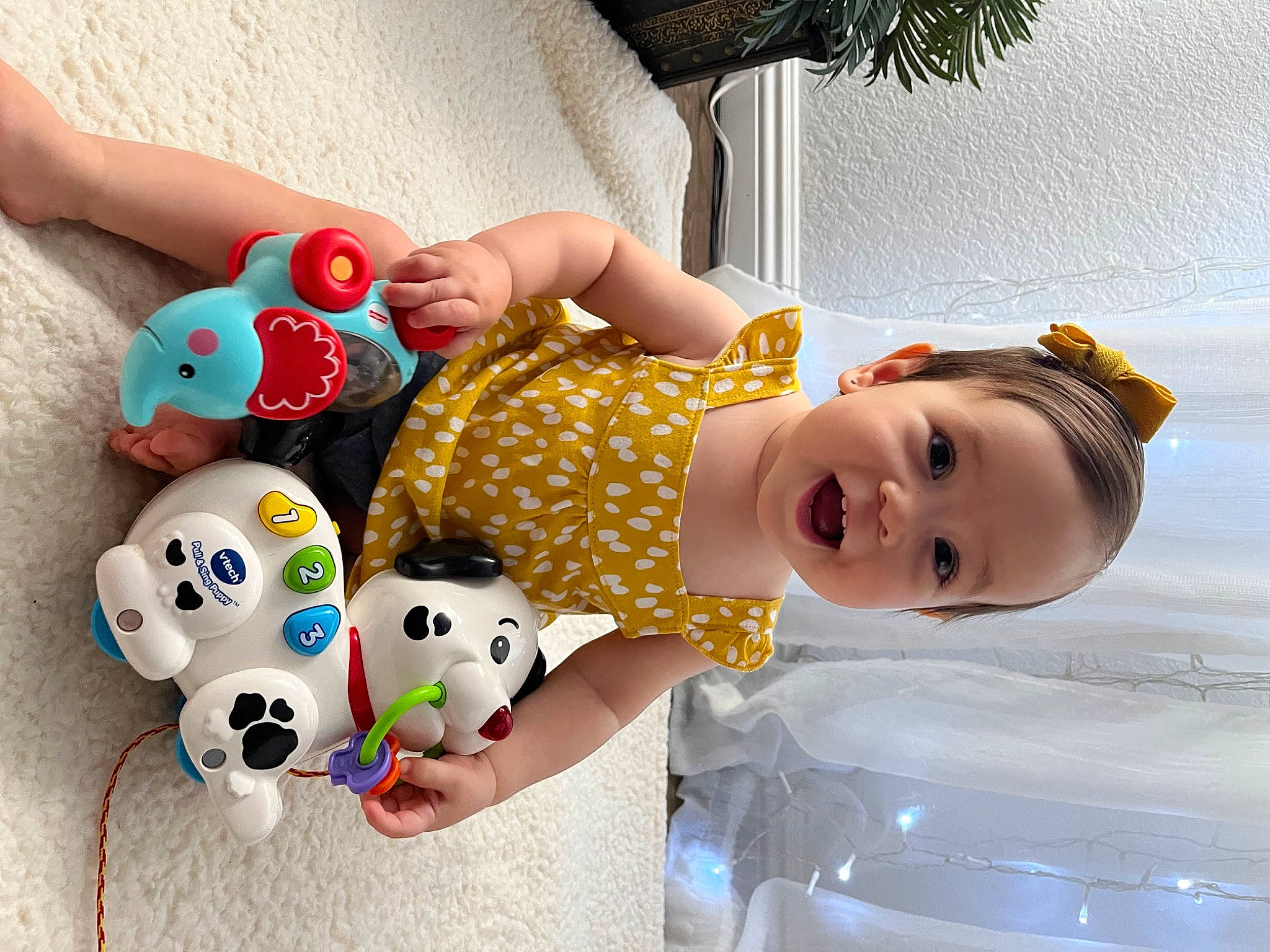Isabel joined the competition — help win amazing prizes! baby, baby_playing_with_toys, baby_products, baby_toddler_clothing, baby_toys, child, facial_expression, fun, happy, houseplant, pattern, person, plant, play, smile, stuffed_toy, textile, toddler, toy, vertebrate
