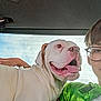 Joany joined the competition — help win amazing prizes! dog, white_dog, pet, animal, car_interior, person, glasses, green_shirt, tongue_out, happy, companion, window, backseat, candid, portrait, young_person, smiling, casual, indoor, friendship