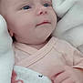 baby, infant, blanket, soft, blue_eyes, pink_clothing, hand, face, newborn, cute, wrapped, cozy, flamingo_pattern, fabric, sleepwear, portrait, closeup, skin, child, peaceful