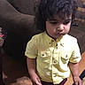Phelopateer joined the competition — help win amazing prizes! carpet, casual_clothing, child, couch, curly_hair, furniture, home_interior, indoor, living_room, party_hat, person, portrait, serious_expression, sofa, standing, toddler, wooden_floor, yellow_shirt, young_child