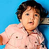 baby, blue_background, button, button_up, child, clothing, curly, curly_hair, cute, expression, eyes, face, head, indoor, person, pink_shirt, portrait, skin, toddler, young_child
