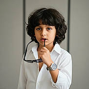 Christiano joined the competition — help win amazing prizes! accessory, casual, child, contemplative, curly_hair, expression, eyes, face, fashion, hair, hand, indoor, minimalist, person, portrait, style, sunglasses, watch, white_shirt, young