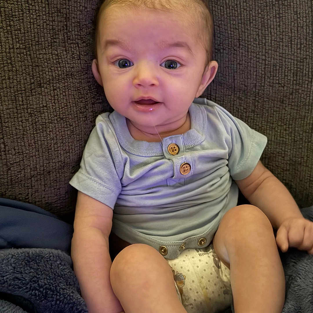 Kashten joined the competition — help win amazing prizes! baby, blanket, child, clothing, comfort, couch, cute, diaper, drool, expression, face, foot, hand, indoor, infant, onesie, portrait, sitting, skin, texture