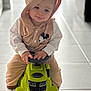 Mathéo participe au concours pour gagner de l'argent avec cette photo : child, toddler, hoodie, mickey_mouse, toy_car, ride_on_toy, green_toy, indoor, tile_floor, steering_wheel, sitting, hands, white_socks, cute, portrait, soft_light, playtime, casual_clothing, smile, babywear