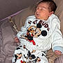 Julien a rejoint le concours — aidez-le/la à gagner de superbes lots ! baby, sleeping, mickey_mouse, clothing, pajamas, slippers, bed, pillow, child, infant, cute, cartoon_characters, soft, indoors, relaxing, peaceful, person, young_child, resting, home