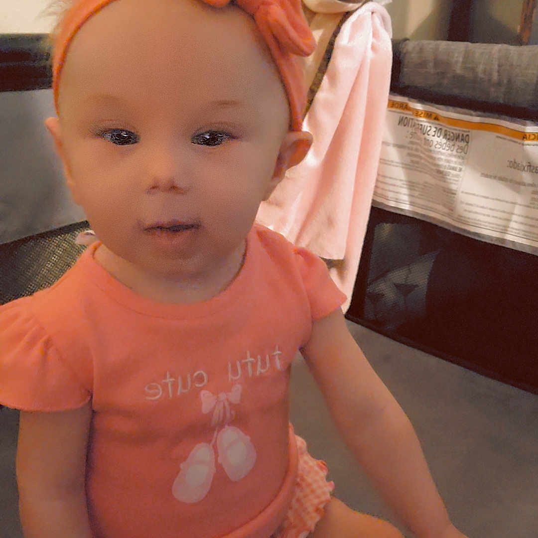 Rosalynn is registered to the contest to win money with this photo: baby, bodypart, bonnet, clothing, couch, doll, face, finger, footwear, furniture, hand, hat, head, person, photography, portrait, shoe, sitting, sneaker, toy