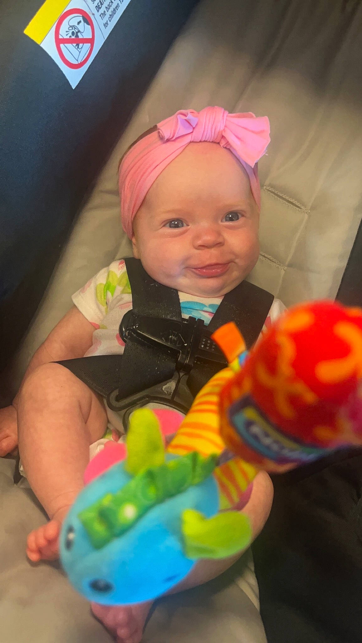 Serenity is registered to the contest to win money with this photo: baby, baby_playing_with_toys, baby_products, baby_toddler_clothing, baby_toys, cap, cheek, child, fashion_accessory, finger, fun, happy, headwear, party_supply, person, personal_protective_equipment, pink, play, room, sitting