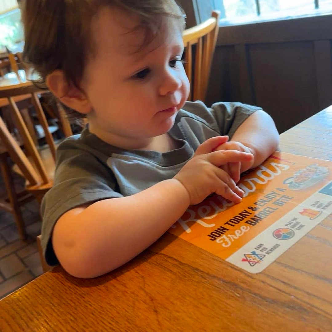 Jonah is registered to the contest to win money with this photo: architecture, boy, building, child, diningroom, diningtable, face, furniture, hardwood, head, indoors, interiordesign, male, person, photography, portrait, room, sitting, table, wood