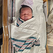 David joined the competition — help win amazing prizes! newborn, baby, swaddled, blanket, hospital, bassinet, sleeping, infant, cap, face, peaceful, wrapped, bed, person, child, cute, soft, resting, healthcare, newborncare