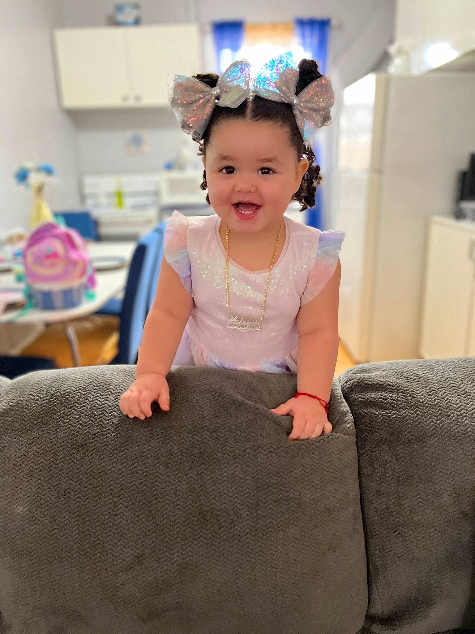 Malaysia is registered to the contest to win money with this photo: baby_toddler_clothing, blue, child, comfort, event, face, flash_photography, flooring, fun, hair, happy, joy, leisure, magenta, neck, person, room, sitting, sleeve, smile