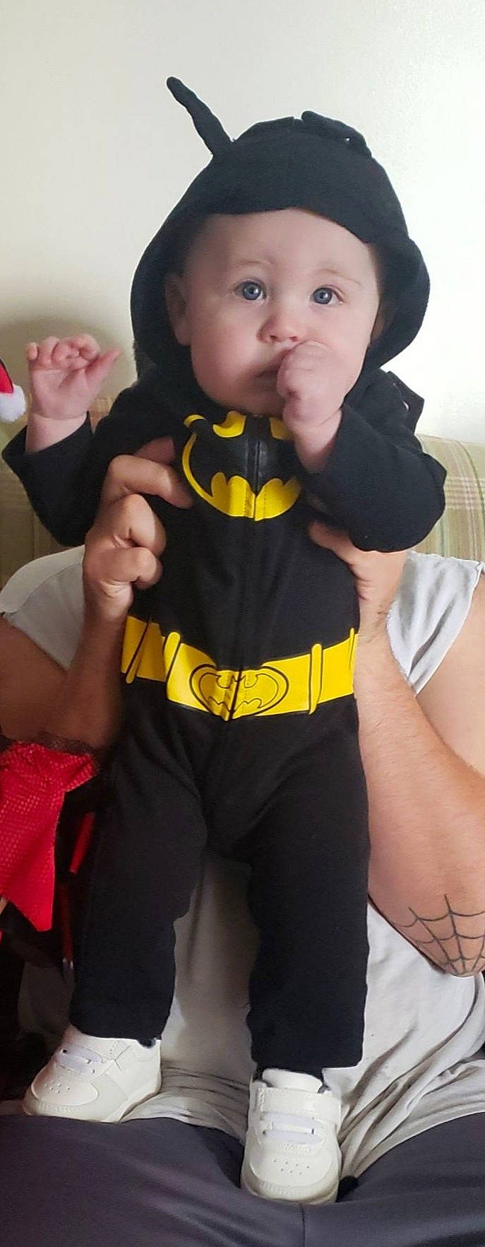 Johnathan is registered to the contest to win money with this photo: baby, baby_toddler_clothing, black, black_hair, eye, face, finger, gesture, hand, happy, hat, headwear, person, personal_protective_equipment, skin, sleeve, t_shirt, thigh, thumb, toddler