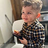 Liyano a rejoint le concours — aidez-le/la à gagner de superbes lots ! child, toddler, smile, plaid_shirt, haircut, indoor, chair, snack, phone, happy, portrait, cute, young, casual_clothing, face, hands, light, background_blur, seated, curious