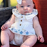 Blakely joined the competition — help win amazing prizes! baby, child, infant, white_dress, bow_headband, blue_eyes, sitting, cushion, red_cushion, outdoor, sunlight, wicker_chair, cute, portrait, plump_legs, hand, foot, soft_light, closeup, relaxed