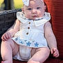 baby, child, infant, white_dress, bow_headband, blue_eyes, sitting, cushion, red_cushion, outdoor, sunlight, wicker_chair, cute, portrait, plump_legs, hand, foot, soft_light, closeup, relaxed