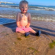 Kayson joined the competition — help win amazing prizes! accessories, baby, beach, clothing, coast, face, head, jewelry, nature, necklace, outdoors, person, photography, portrait, sea, shoreline, shorts, sitting, summer, water