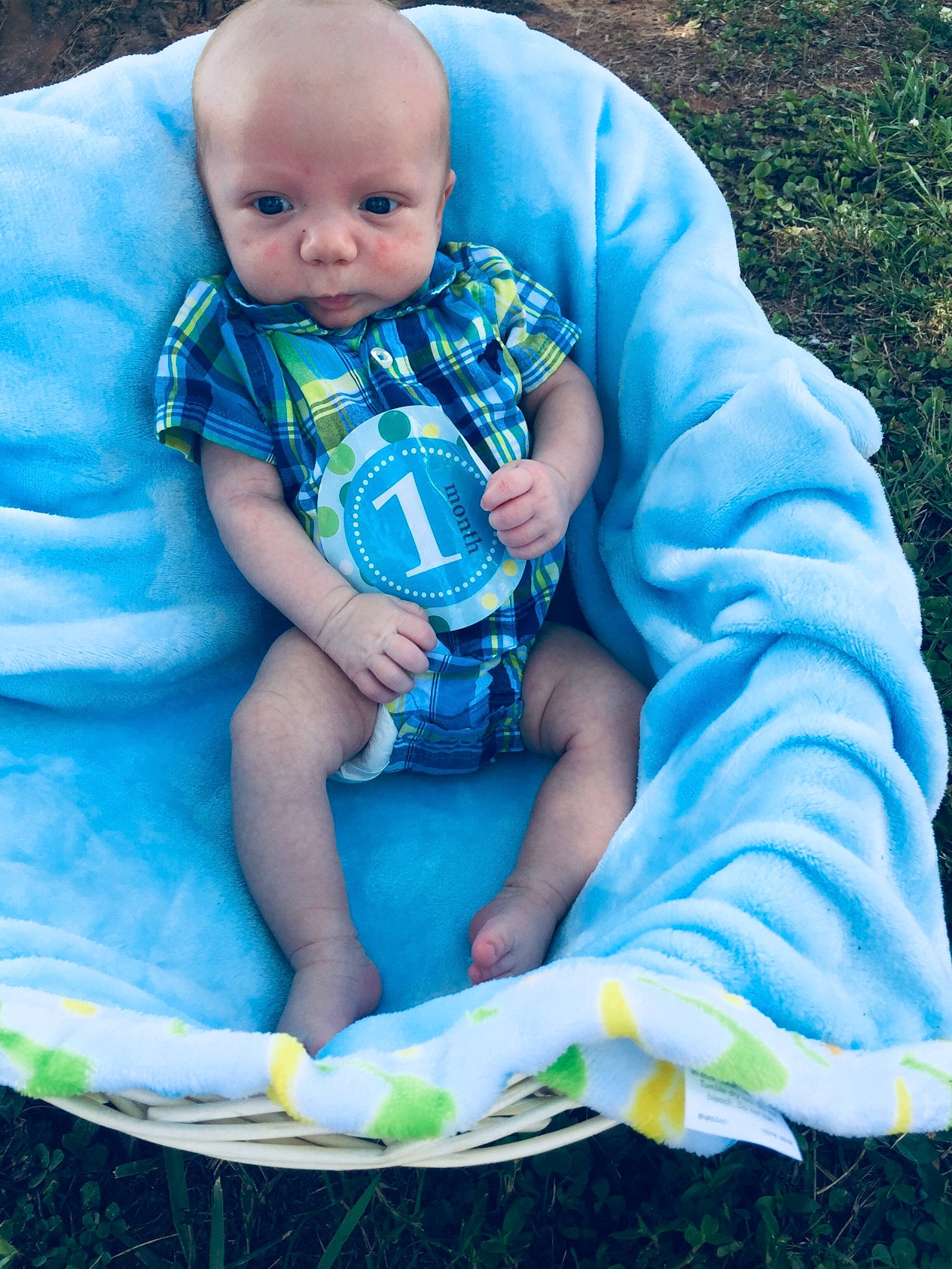 Maddix is registered to the contest to win money with this photo: baby, baby_products, baby_toddler_clothing, child, grass, person, sitting, smile, toddler