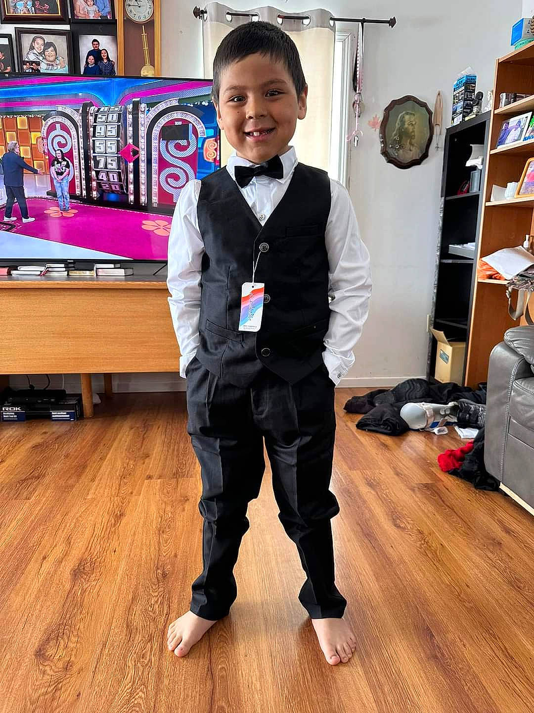 Brody is registered to the contest to win money with this photo: blazer, collar, denim, dress_shirt, fashion_design, flooring, formal_wear, happy, hardwood, joy, laminate_flooring, person, shelf, shelving, sleeve, smile, sportswear, t_shirt, tie, toddler