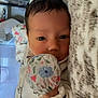 Willow joined the competition — help win amazing prizes! baby, infant, face, blanket, mitten, floral_pattern, close_up, lying_down, cozy, child, cute, indoors, soft, sleepwear, portrait, newborn, skin, hand, expression, young
