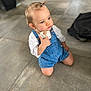 Alix participe au concours pour gagner de l'argent avec cette photo : toddler, child, denim_overalls, white_shirt, kneeling, indoor, concrete_floor, blue_eyes, ponytail, curious, casual_clothing, small_hands, cute, young_child, portrait, person, baby, innocent, looking_away, floor