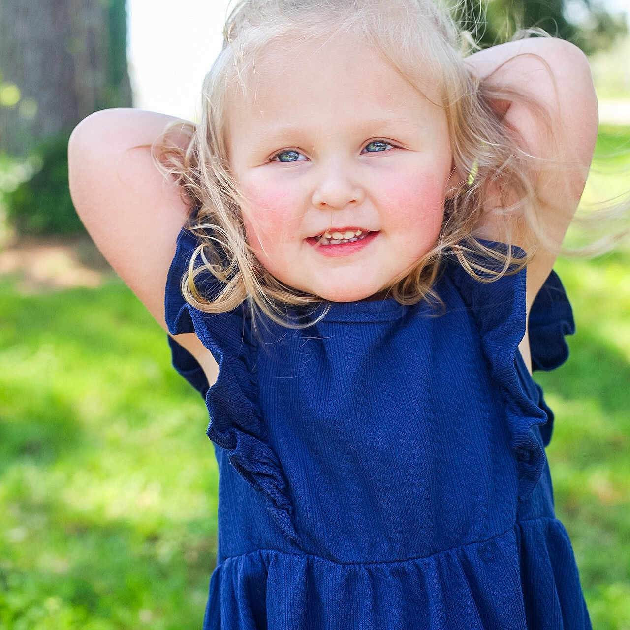 Cadence joined the competition — help win amazing prizes! blonde_hair, blue_dress, bow, child, curly_hair, cute, fashion, girl, grass, greenery, happy, nature, outdoor, person, playful, portrait, smile, sunlight, tree, young