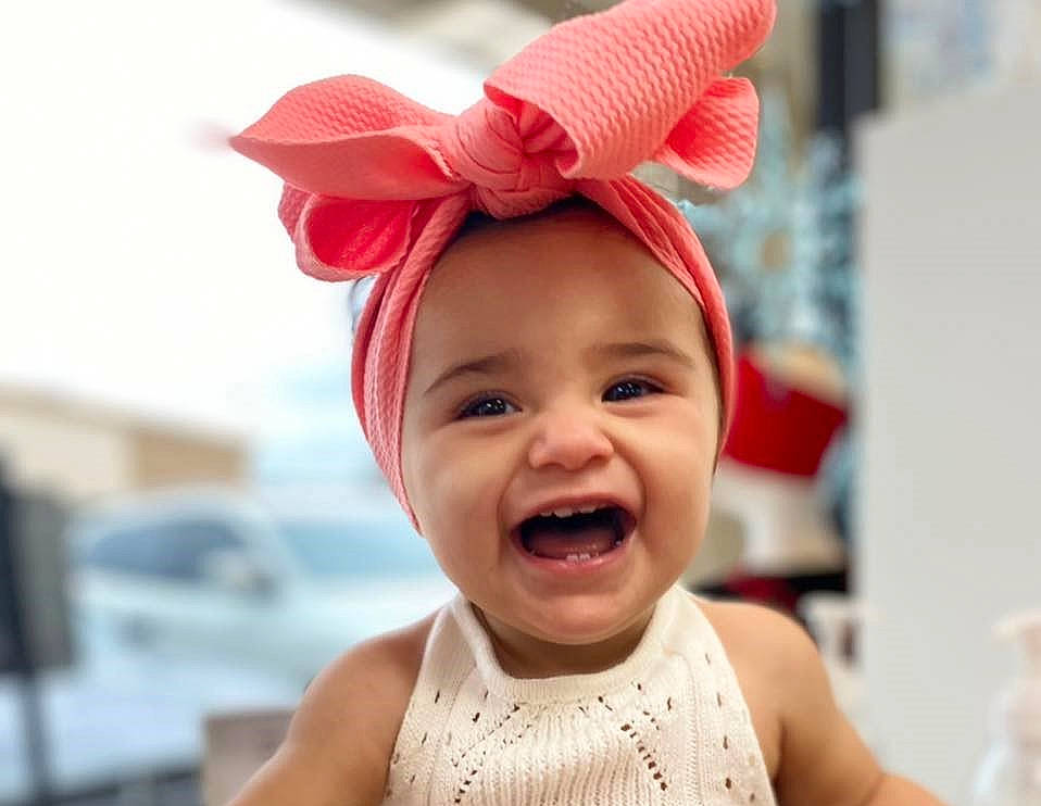 Leilani is registered to the contest to win money with this photo: baby, baby_toddler_clothing, chin, costume_hat, ear, event, eye, face, fun, happy, head, headgear, headpiece, human_body, lip, mouth, nose, person, smile, toddler