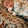 Camryn joined the competition — help win amazing prizes! baby, sleeping, infant, floral_clothing, onesie, cushion, animal_print, soft_fabric, peaceful, closeup, portrait, indoors, cute, child, resting, face, hand, cozy, blanket, newborn