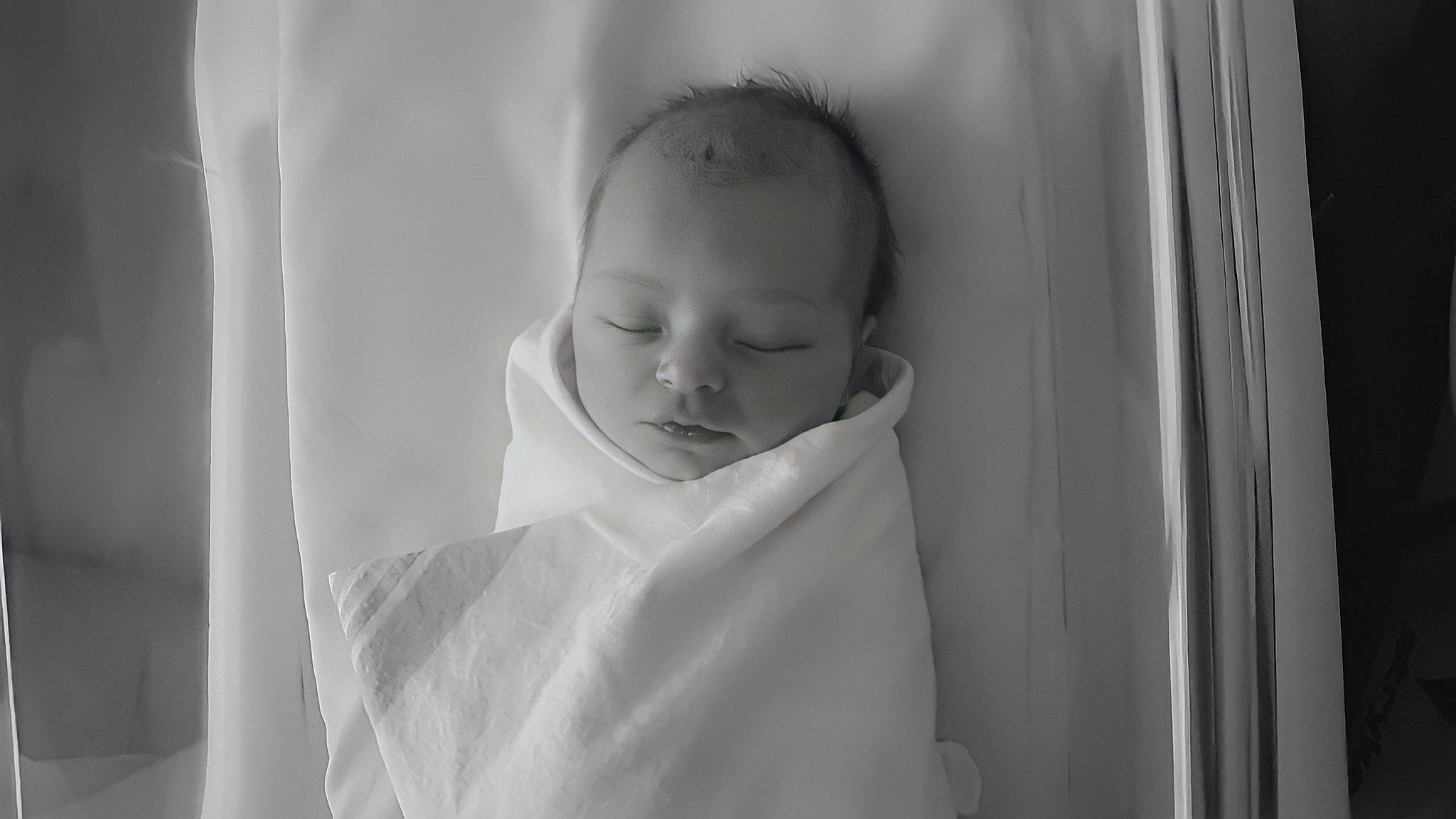 Daisy is registered to the contest to win money with this photo: baby, baby_toddler_clothing, black_and_white, child, comfort, dress, eye, eyebrow, face, flash_photography, gesture, happy, iris, monochrome, monochrome_photography, person, portrait_photography, room, sleeve, style