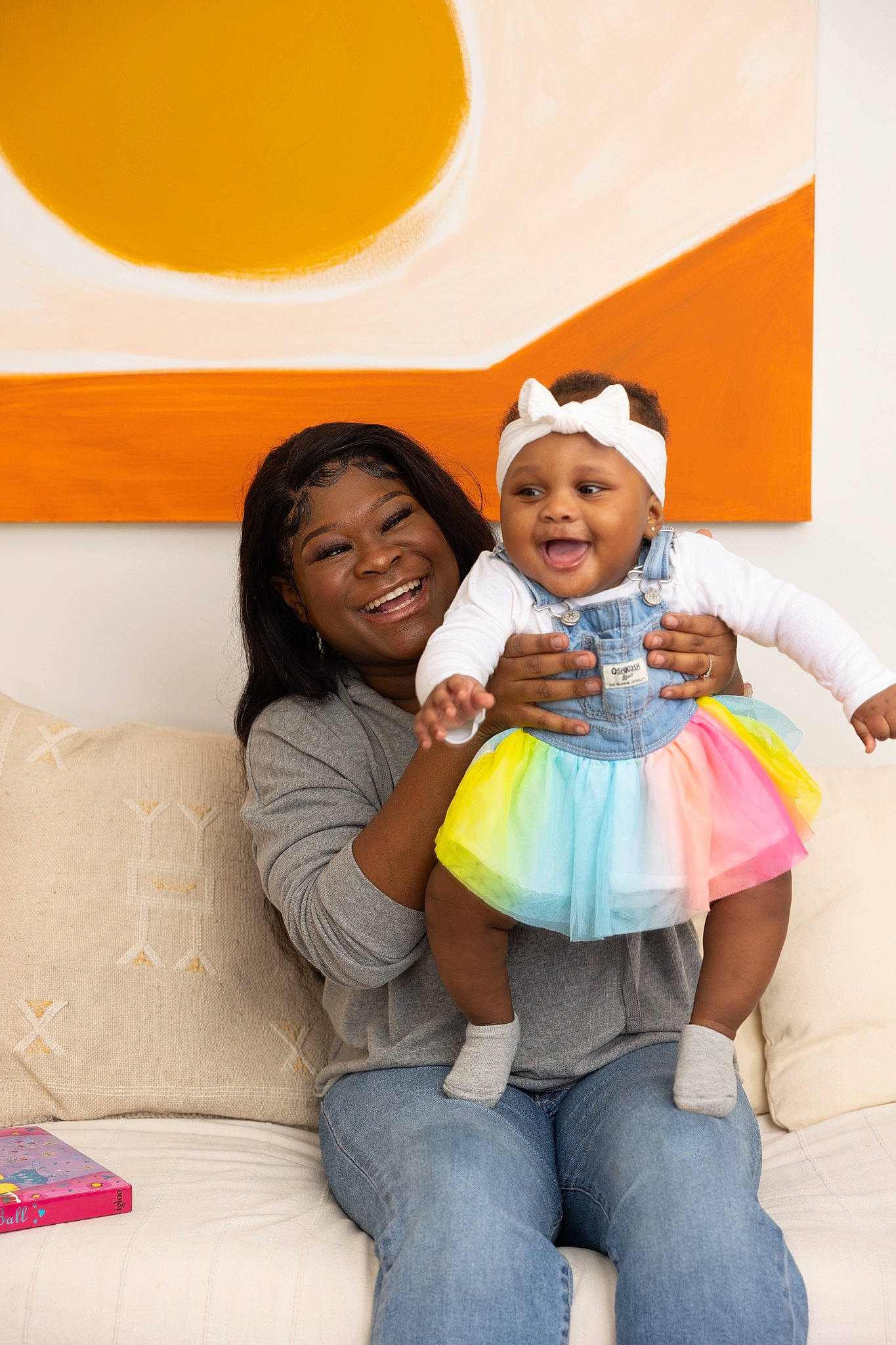 Alora joined the competition — help win amazing prizes! baby, baby_toddler_clothing, child, comfort, couch, event, eye, fun, gesture, happy, headwear, jeans, joy, leisure, person, room, sitting, skin, smile, t_shirt