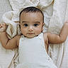 baby, infant, child, blanket, soft, cute, portrait, lying_down, clothing, white_outfit, arms_outstretched, indoors, skin, face, head, eyes, hands, expression, young, adorable