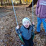 child, toddler, swing, playground, autumn, leaves, tree, hat, jacket, shoes, smile, outdoor, person, adult, fall, play, fun, happy, nature, park