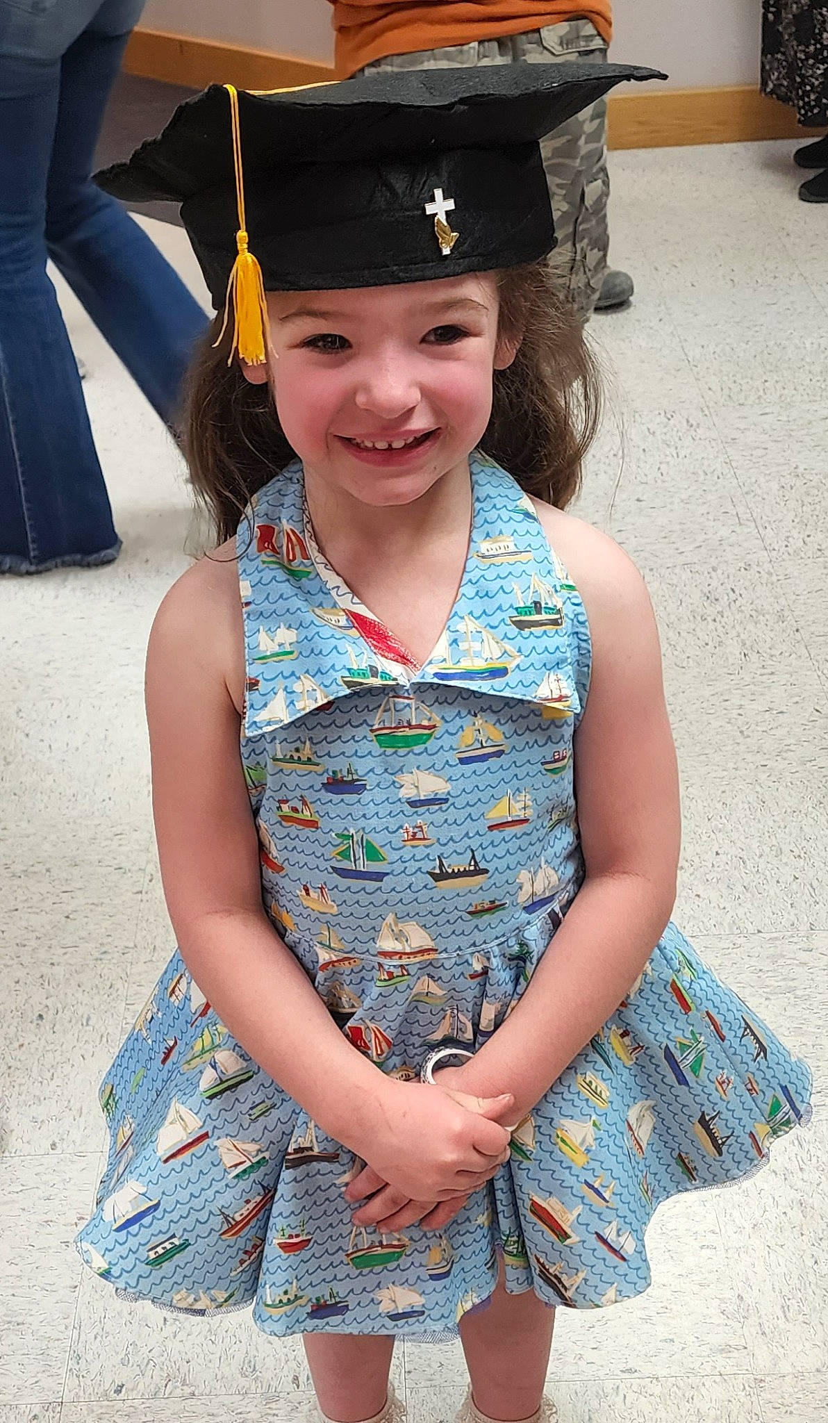 Freya is registered to the contest to win money with this photo: academic_dress, academic_institution, child, day_dress, dress, electric_blue, event, facial_expression, fun, happy, headgear, headwear, joy, mortarboard, one_piece_garment, person, scholar, sleeve, smile, toddler