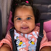 A Riyah Hall joined the competition — help win amazing prizes! baby, child, smiling, face, hair, pink, shirt, cartoon, seatbelt, car_seat, straps, cute, happy, skin, person, indoors, closeup, infant, hair_tie, playful