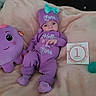 Lana is registered to the contest to win money with this photo: baby, blanket, businesscard, clothing, face, furniture, hat, head, hosiery, newborn, number, paper, person, photography, portrait, purple, sock, symbol, text, toy