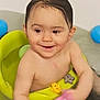 baby, bath, bathroom, blue_ball, child, cleaning, face, green_bath_seat, happy, infant, person, pink_toy, play, sitting, skin, smile, toddler, toy, water, wet_hair