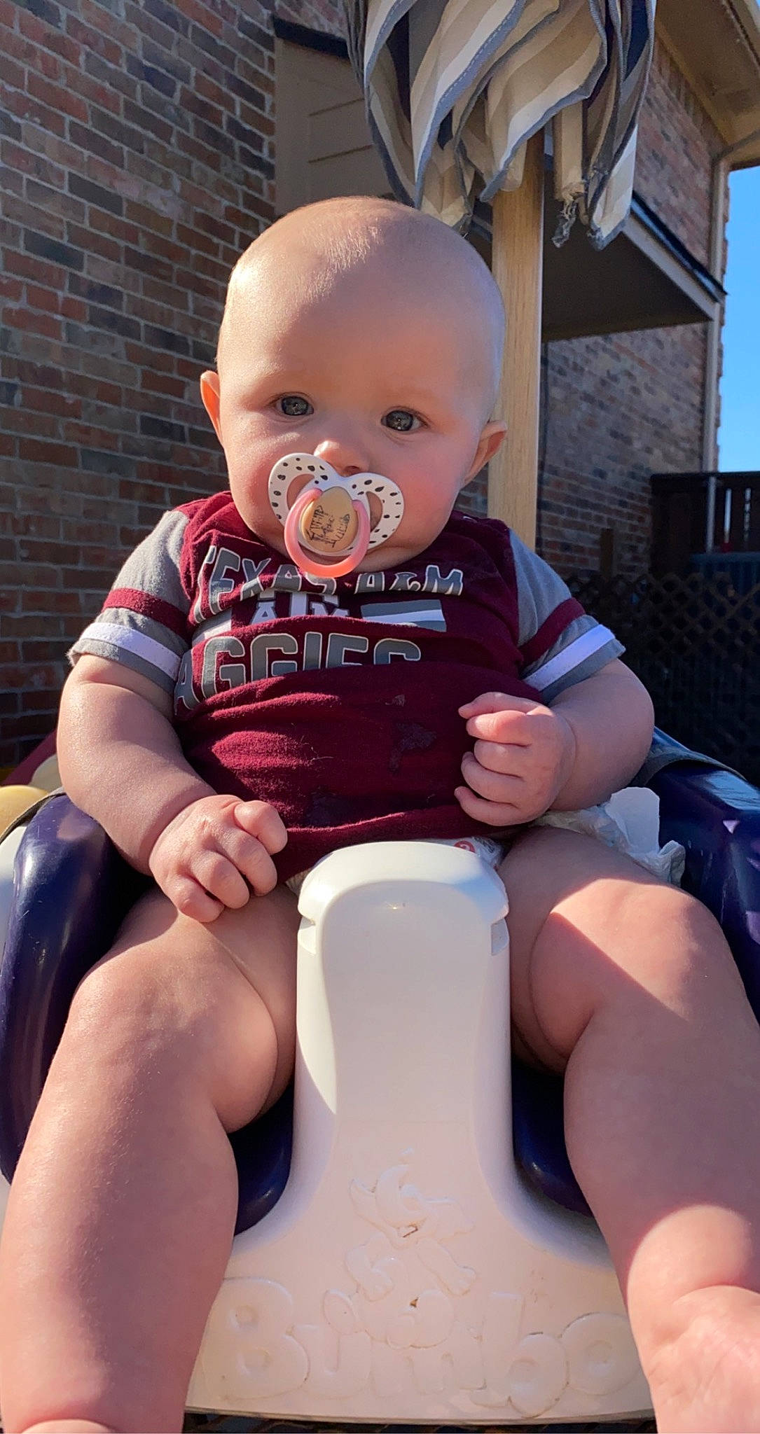 Paisley is registered to the contest to win money with this photo: baby, baby_toddler_clothing, child, comfort, electric_blue, fun, happy, human_leg, knee, lap, leg, leisure, mouth, muscle, person, pink, sitting, skin, summer, thigh