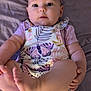 Lainey is registered to the contest to win money with this photo: baby, child, infant, romper, butterfly_pattern, foot, hand, bed, bedding, soft, cute, skin, face, eyes, legs, sitting, lying, clothing, portrait, indoors
